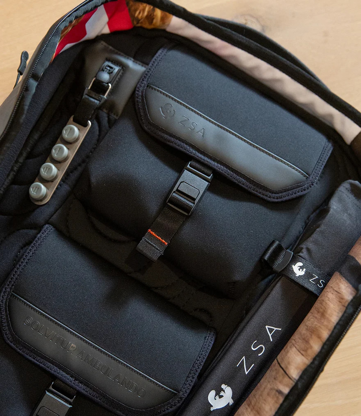 The ZSA Panel's two dedicated neoprene keyboard pockets, one per split-keyboard half, secured with adjustable cinch buckles.