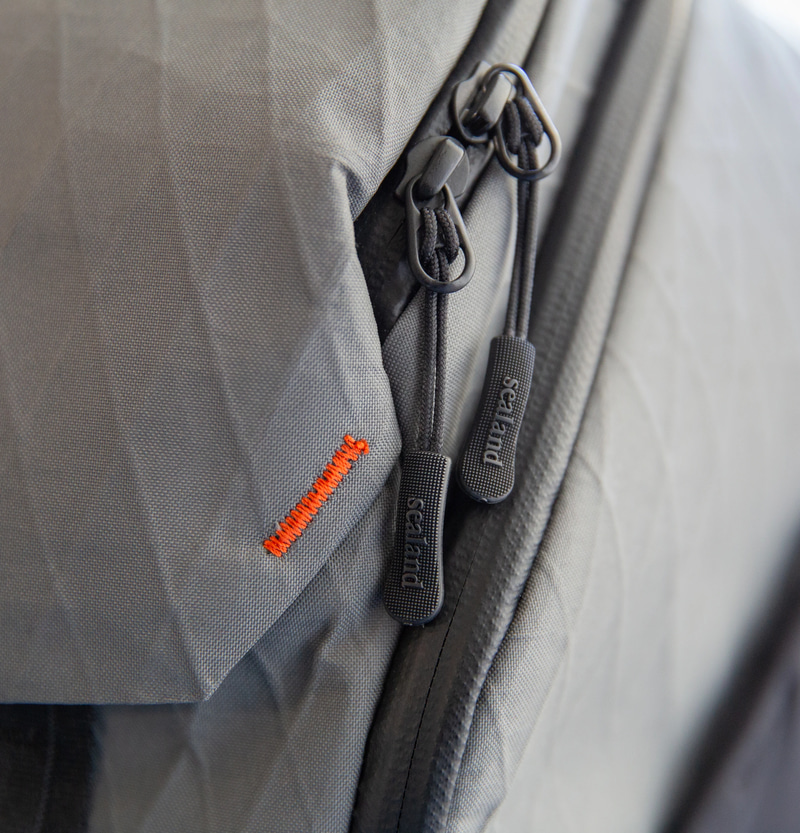 Side profile view of the ZSA Backpack showing its slim, structured silhouette and waterproof zippers