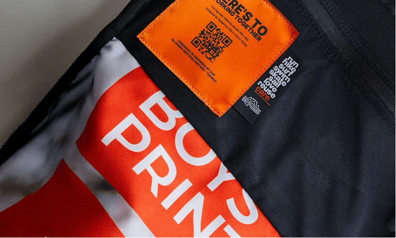 Close-up of the ZSA Backpack inner pocket featuring a vibrant, one-of-a-kind pattern from a recycled billboard banner.