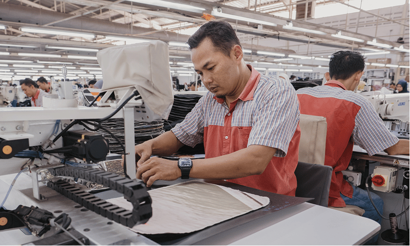 A skilled worker assembling a ZSA Backpack on an industrial sewing machine at Tasindo’s factory in Indonesia.